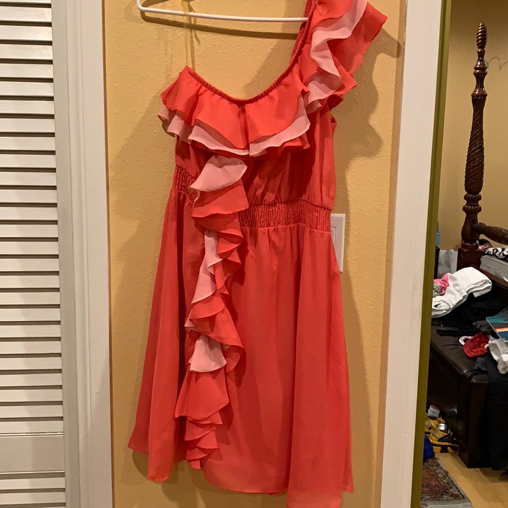 Salmon color one shoulder dress.